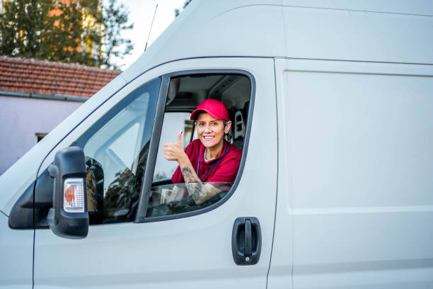 istock Smiling delivery woman in the van 1785779645