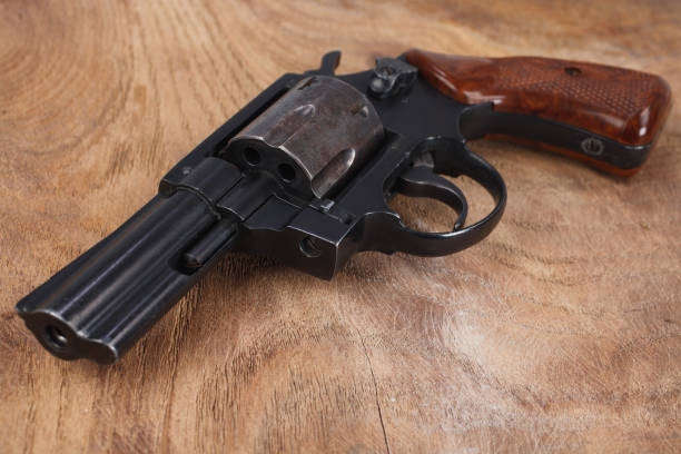 istock Revolver on wooden table 1785779664
