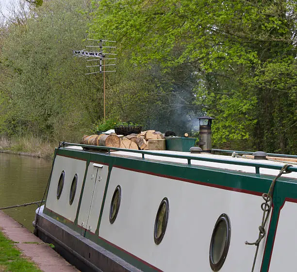 Chimney smoking and logs aboard so snug and warm on this canal barge on the Shropshire Union canal.