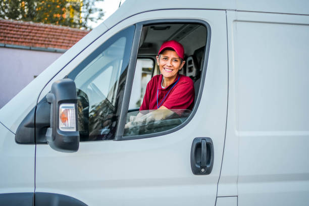 istock Smiling delivery woman in the van 1785780194