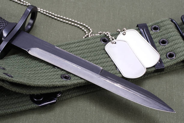 M16 rifle bayonet on US olive drab uniform background