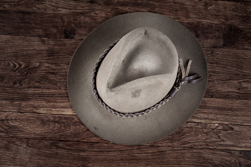 Old west hat on wooden table.