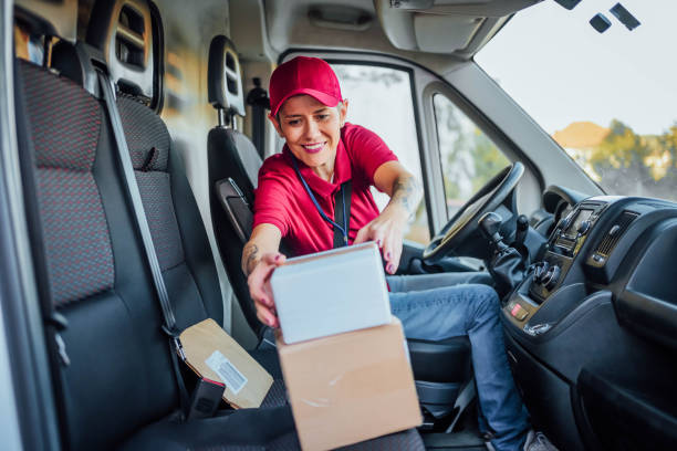 istock Female courier at delivery van 1785784503