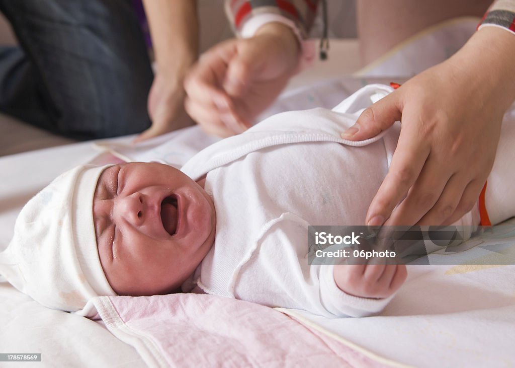 Newborn baby crying on the bed Newborn baby crying on the bed, selective focus. Baby - Human Age Stock Photo