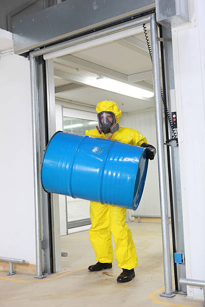 istock technician lifting barrel of toxic substance 178578797