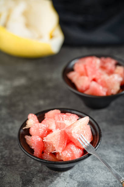 istock Sunlight shining on grapefruits with red flesh placed on a slate board in a bowl 1785793861