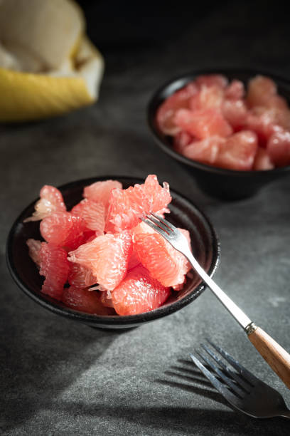 istock Sunlight shining on grapefruits with red flesh placed on a slate board in a bowl 1785793863