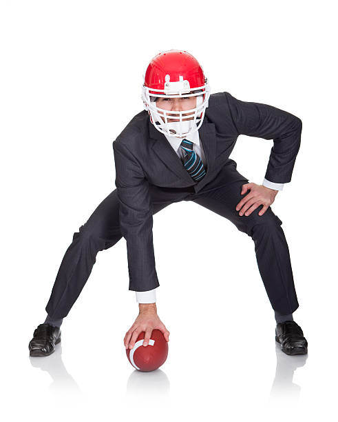 istock Competitive businessman playing american football 178579403