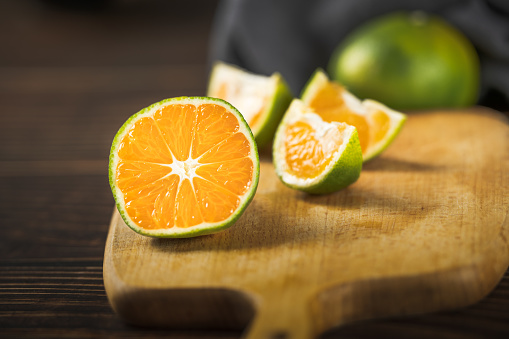 Oranges placed on a wooden board.