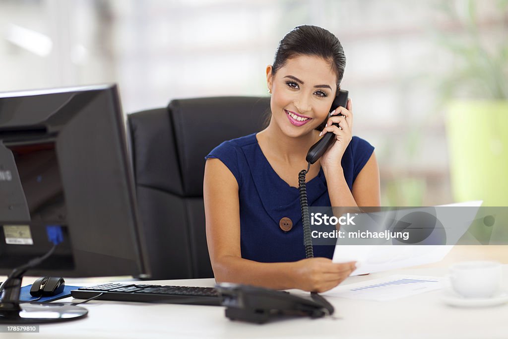 secretary answering telephone portrait of young secretary answering telephone Secretary Stock Photo