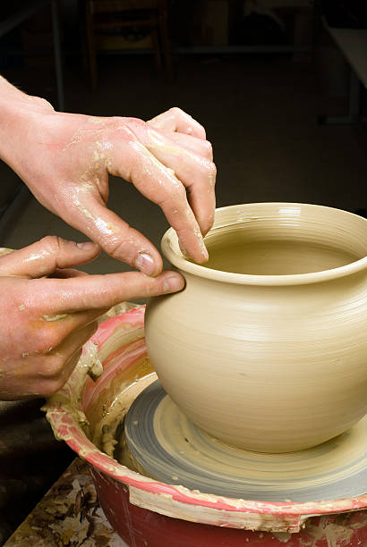 istock hands of a potter, creating an earthen jar 178579951