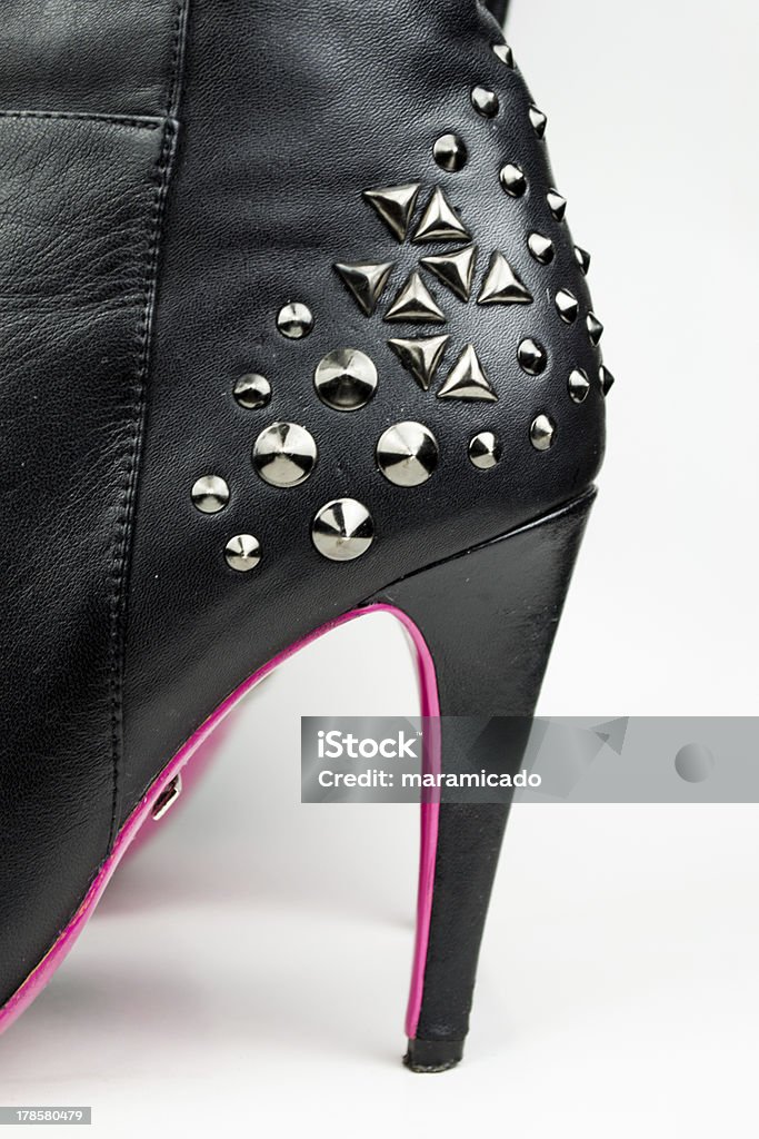 Female high boots with spikes isolated on white Black Color Stock Photo