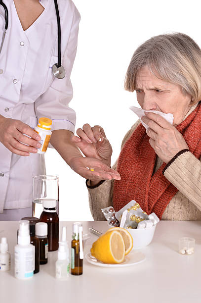 istock elderly woman taking pills 178580740