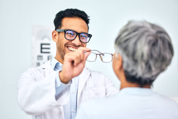istock Glasses, optometrist and client with appointment, vision and consultation with diagnosis, smile and help. Office, employee and senior woman with eyewear, doctor and healthcare with wellness and frame 1785807845
