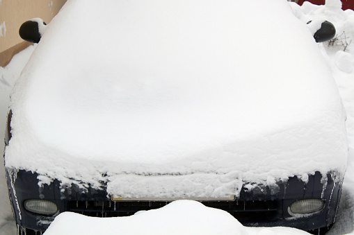 Parked cars under snow cover. Winter parking background