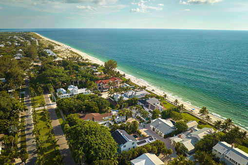 View from above of large residential houses in island small town Boca Grande on Gasparilla Island in southwest Florida. American dream homes as example of real estate development in US suburbs.