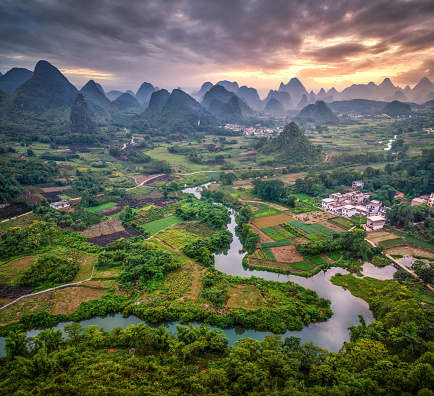 Aerial view and dramatic Sunset Landscape of Guilin , Li River and Karst mountains called Cuiping or Five Finger mount located at Yangshuo county, Guilin, Guangxi Province, China