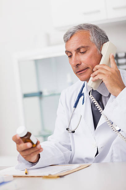istock Doctor holding a phone and drug box 178583111
