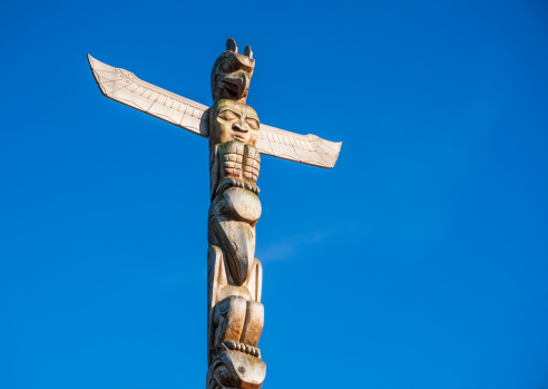 First Nations Totem Poles during a fall season at Stanley Park in Vancouver, British Columbia, Canada.