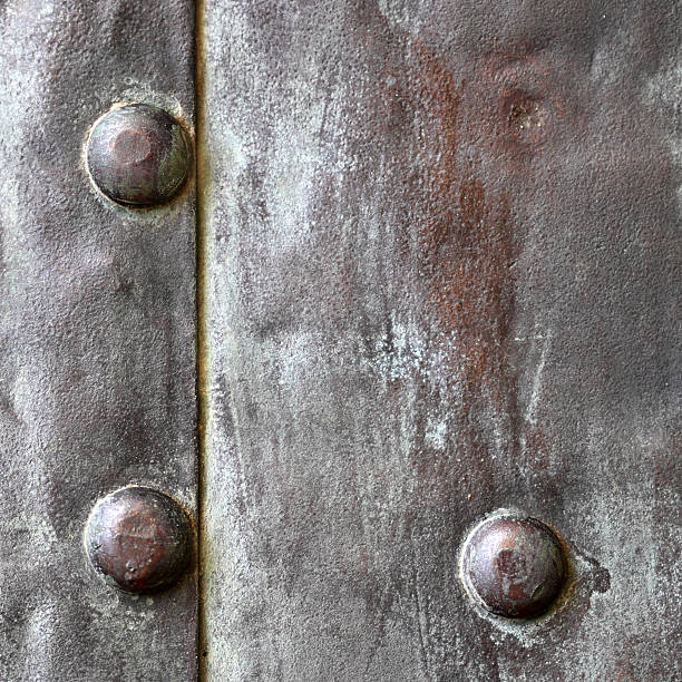 istock Black metal plate or armour texture with rivets 178584074