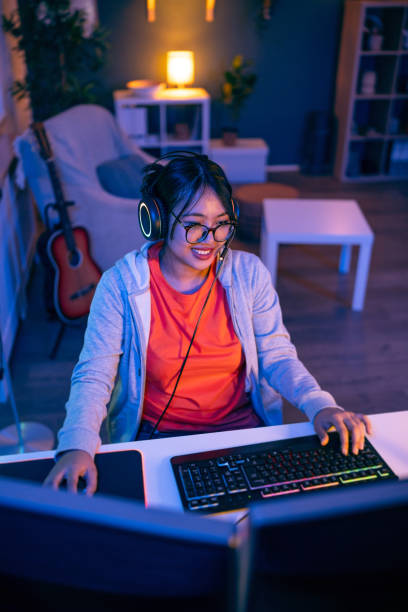 istock Modern female gamer Asian ethnicity playing video game on pC 1785841003