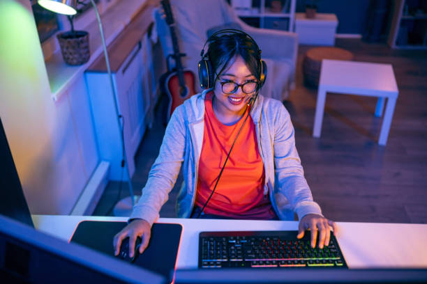 istock Modern female gamer Asian ethnicity playing video game on pC 1785841008