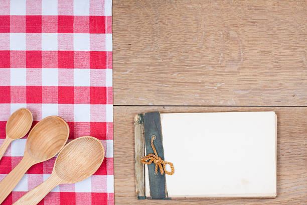 istock Red-white kitchen tablecloth, wooden spoons, old notepad on wood 178584466