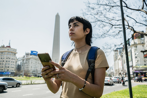 Traveler young woman using mobile phone on Buenos Aires, Argentina