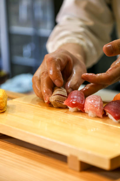 istock Japanese man making nigiri 1785849163
