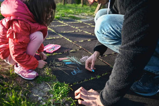 istock unrecognizable family drawing with chalk. 1785849721