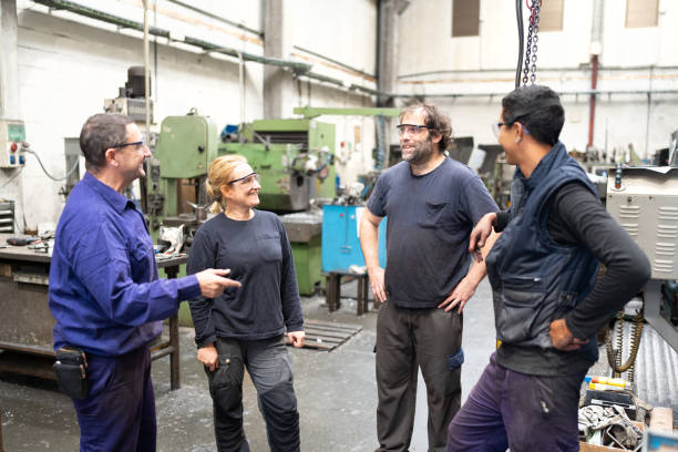 istock Manufacturing coworkers relaxing and talking 1785851939