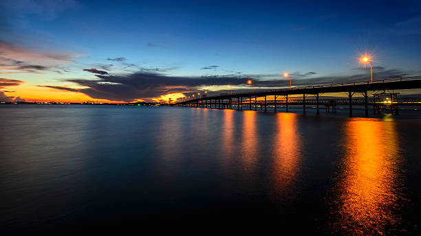 istock Long bridge to the sea at dusk 178585493