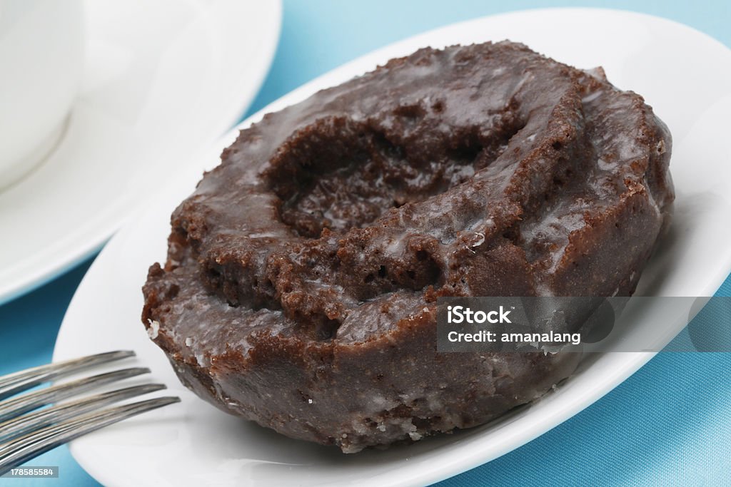 Old Fashioned Chocolate Doughnut An old fashioned chocolate donut Blue Stock Photo