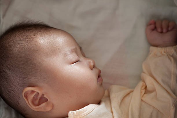 istock Baby sleep soundly and luminous beam on face 178585607