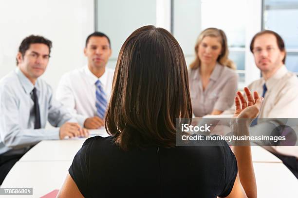 Group Of People Seated Around Boardroom Table Stock Photo - Download Image Now - Meeting, Rear View, Chairperson