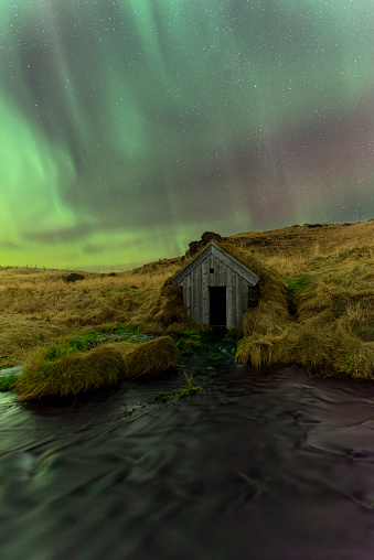 Northern lights (aurora borealis) above a rural hut in Keldur, Rangárvellir, Sudurland, Iceland