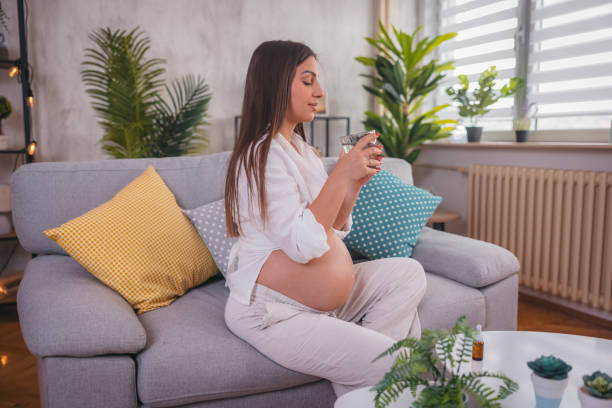 istock Pregnant woman drinking her supplements 1785878248