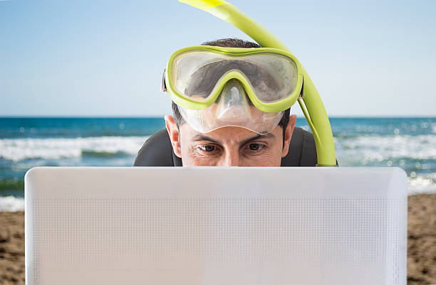istock Man smiling at web prices for his vacation 178588131