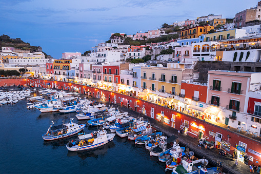 Aerial picture of the famous village of Ponza with illuminated streets and the busy harbour in a summer evening, dusk time, Ponza Island, Pontine archipelago, Tyrrhenian sea, Latina province, Latium, Italy