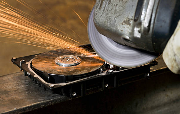 working with angular grinder on open hard drive stock photo