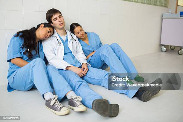 Nurses And Doctor Sleeping While Sitting On The Floor Stock Photo - Download Image Now