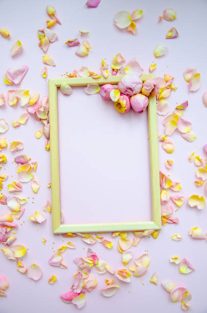 istock Rose petals, rose buds and empty wooden frame on light pink background. Flat lay, copy space. Mother's Day, St. Valentine's Day, March 8 concept. Top view, flat lay. Card design template. 1785901292