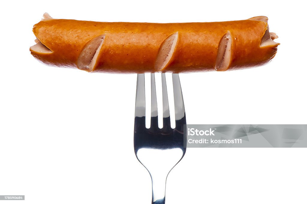 Cooking sausage on  fork Cooking sausage on a fork on a white background Fork Stock Photo