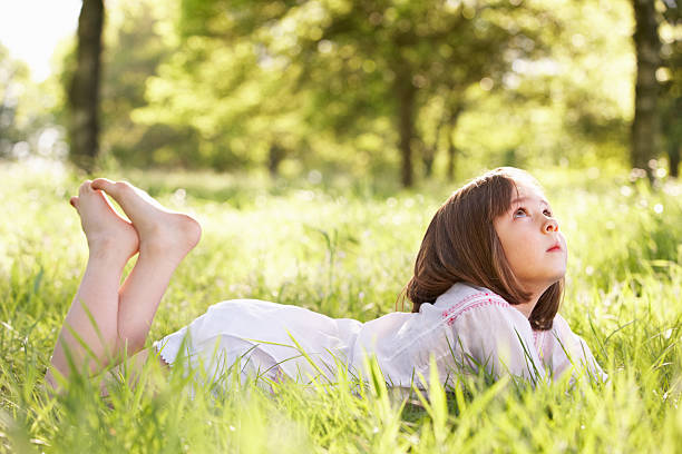 istock Young Girl Daydreaming Lying In Summer Field 178590791
