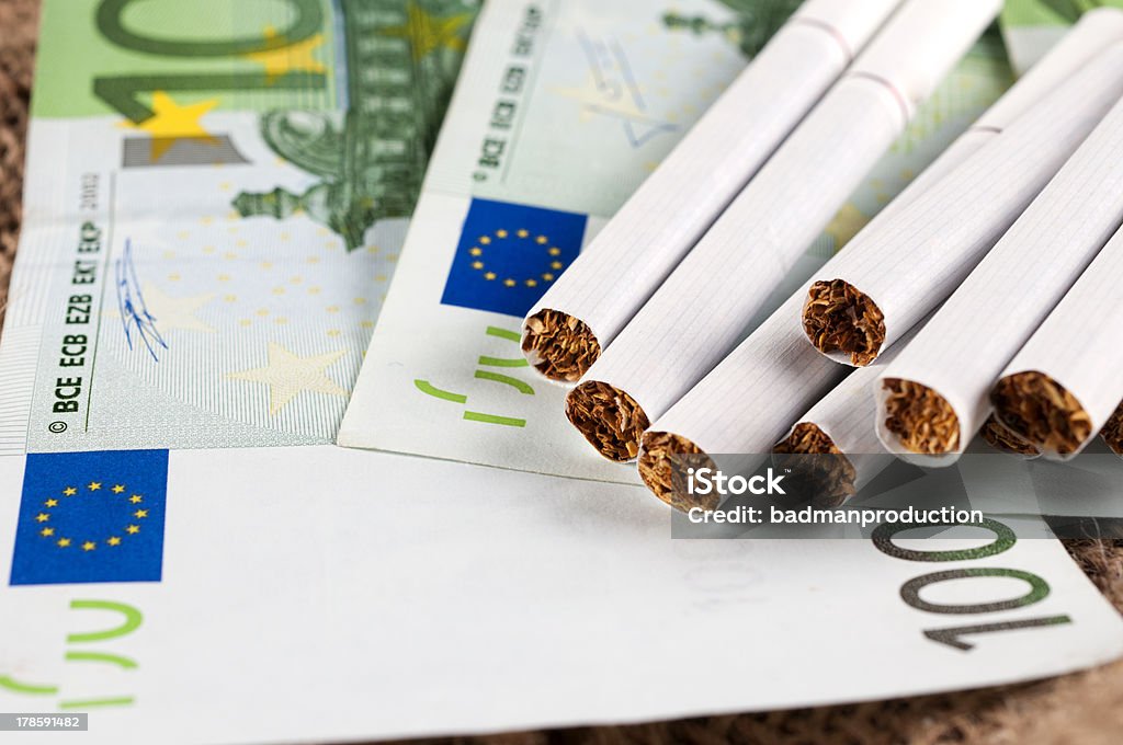 Money and cigarette One hundred euro bills and cigarette Cigarette Stock Photo