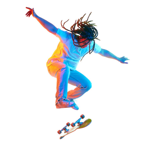 istock Young man doing freestyle modern tricks on skateboard in mixed neon light isolated white studio background. Contemporary kind of sport. 1785916931