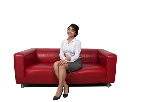 Attractive Asian businesswoman sitting on sofa
