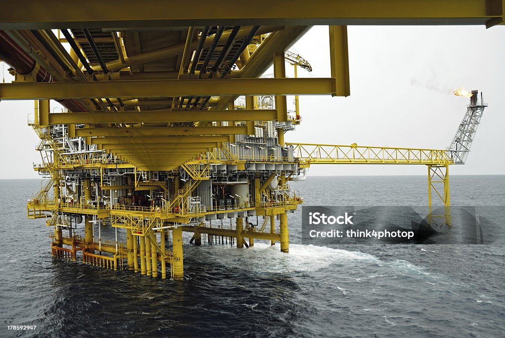 gas flare is on the oil rig platform The gas flare is on the oil rig platform in the gulf of thailand Blue Stock Photo