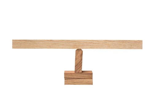 The wooden balancing means on white background