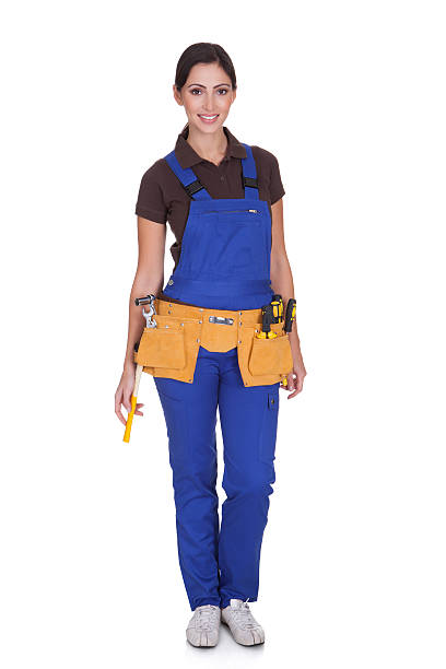 Female Construction Worker With Toolbelt Female Construction Worker With Toolbelt. Isolated On White woman wearing tool belt stock pictures, royalty-free photos & images